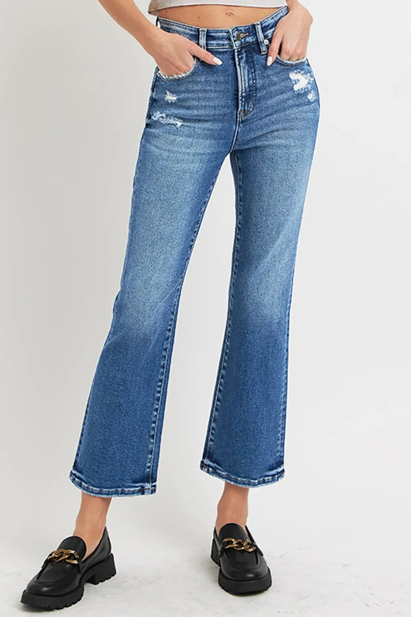 Person wearing blue jeans with a white background