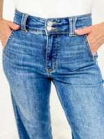 Blue jeans worn by a person on a white background