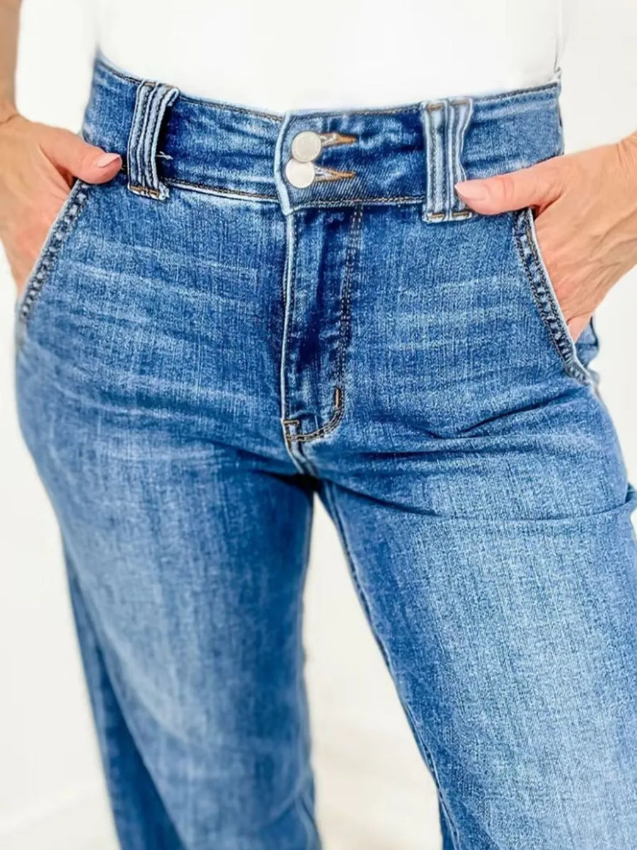 Blue jeans worn by a person on a white background