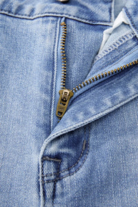 Close-up of a blue denim jacket with a zipper