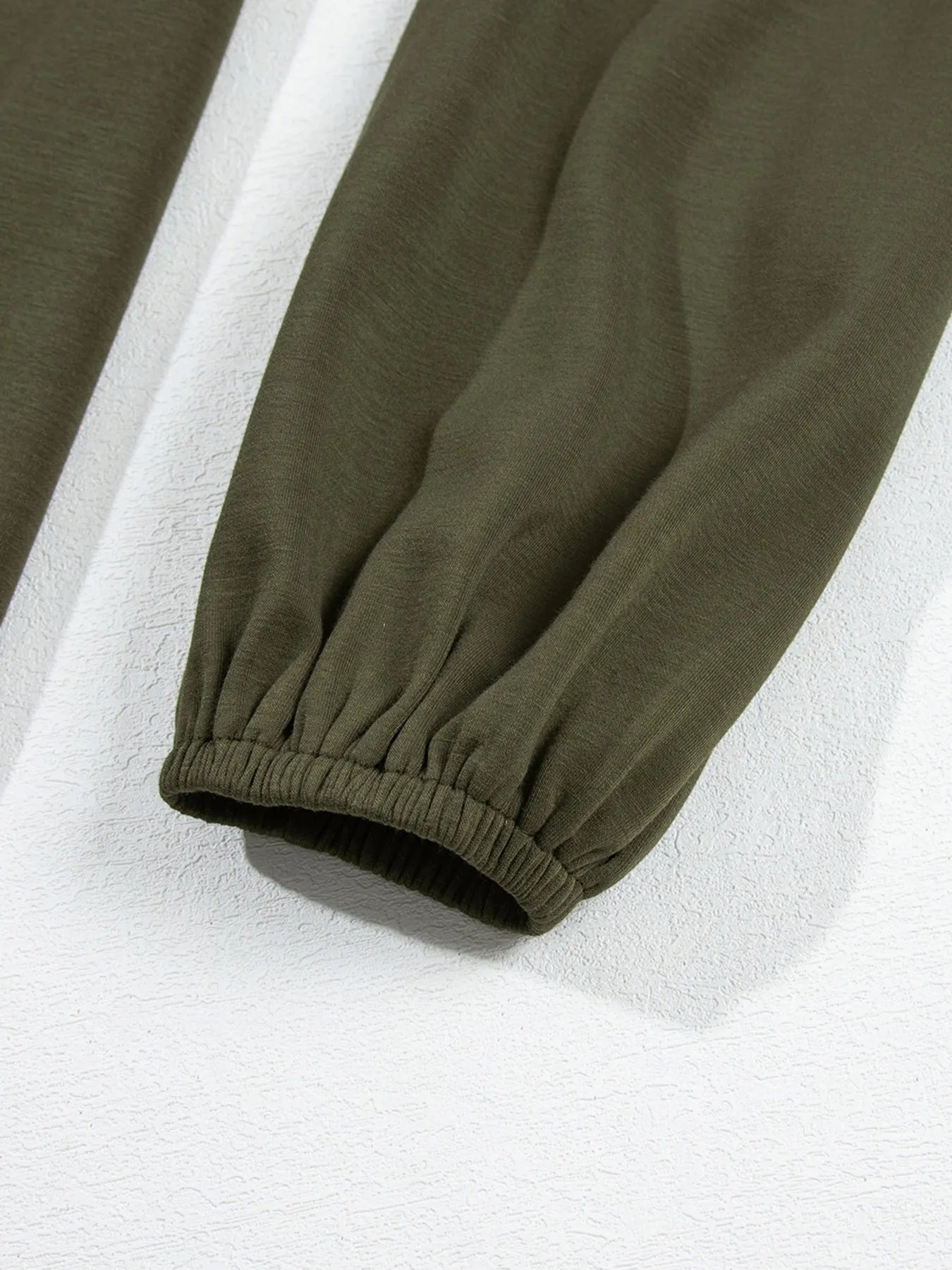 Close-up of green pants with a white background