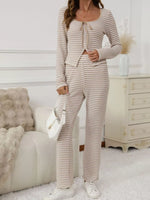 Woman wearing a striped outfit in a cozy living room.