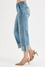 Light blue jeans worn by a person on a white background