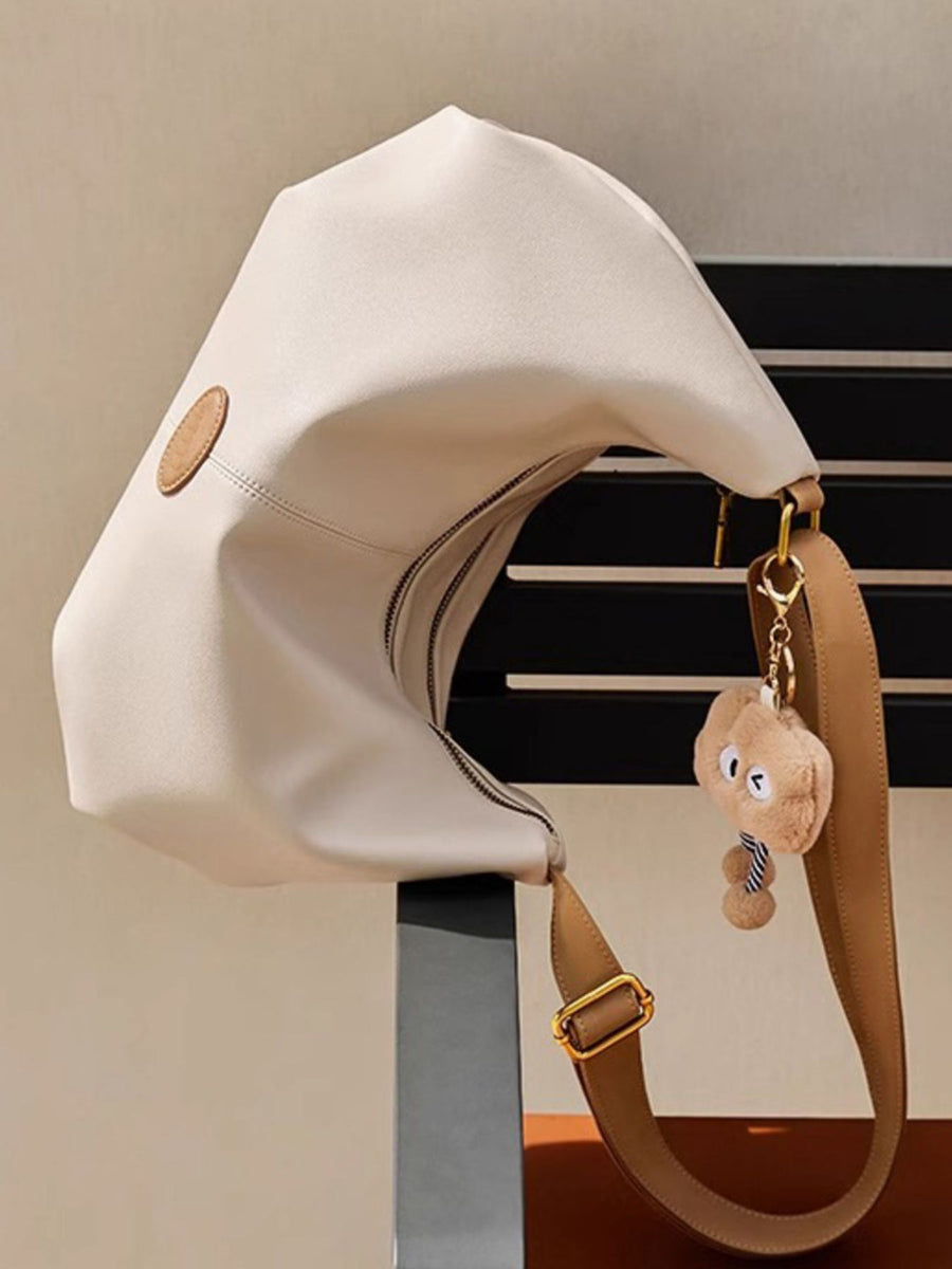 Beige handbag with a unique design on a neutral background