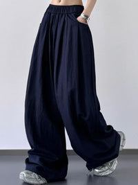 Navy blue wide-leg pants worn by a person on a plain background