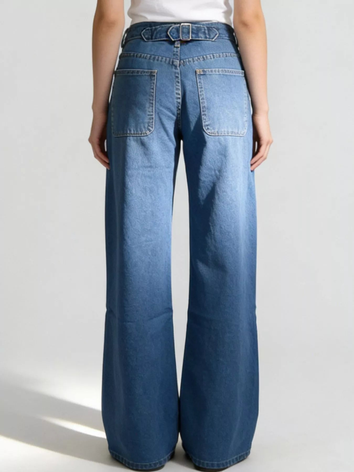 Wide-leg jeans worn by a person on a white background