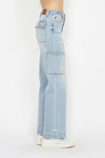Light blue jeans worn by a person on a white background