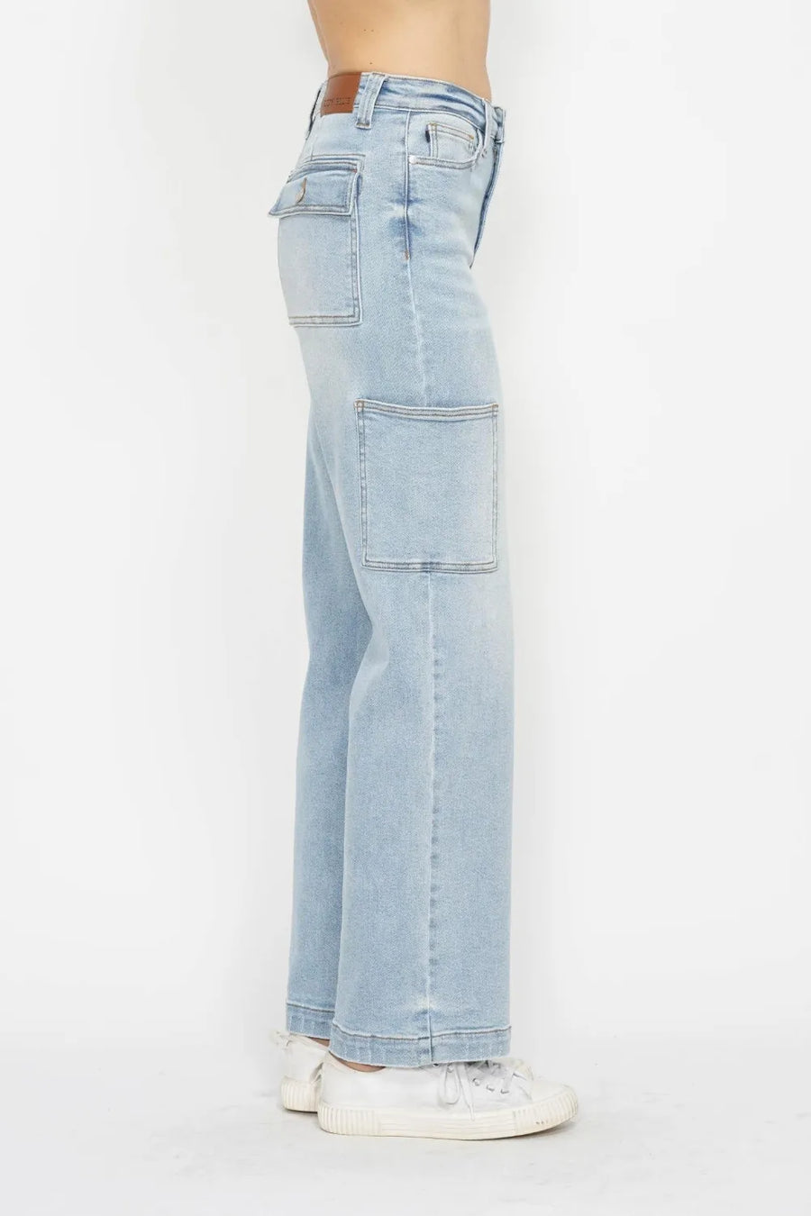 Light blue jeans worn by a person on a white background