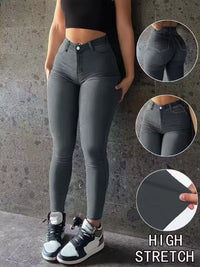 Person wearing high-waisted gray leggings with close-up insets on a textured wall background.