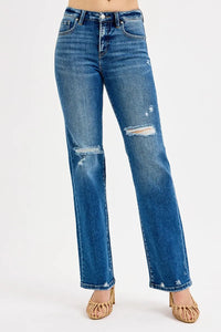 Blue jeans with slight distressing on a white background