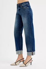 Blue jeans worn by a person on a white background