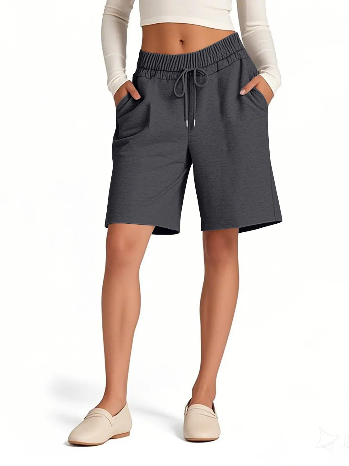 Person wearing gray shorts on a white background