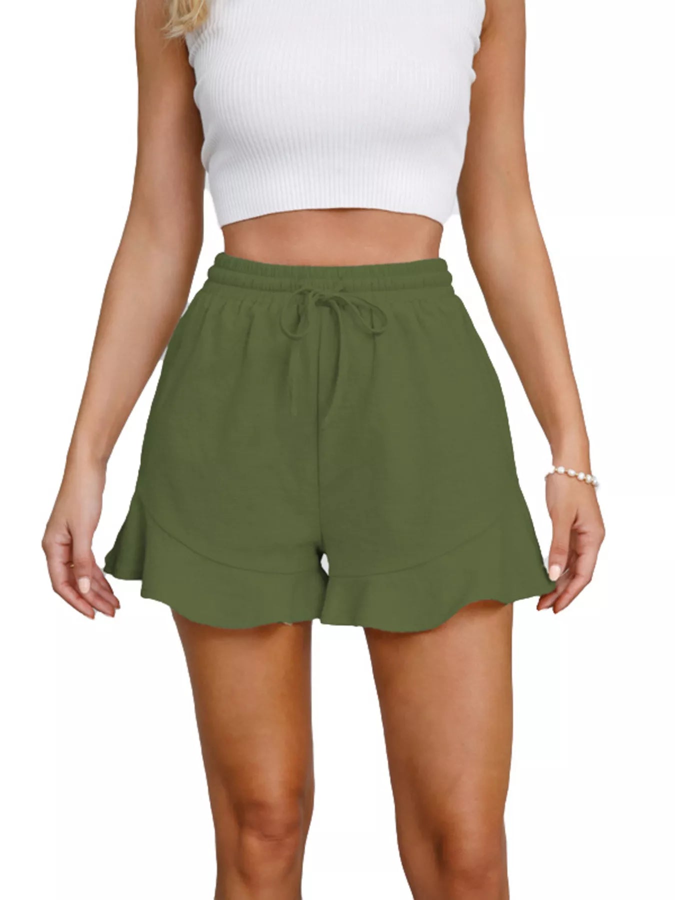 Green shorts worn by a person on a white background