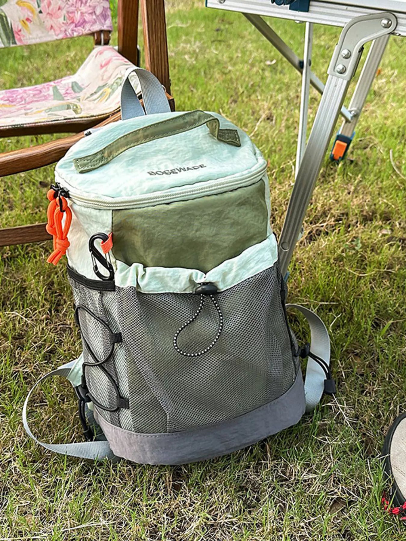 Green and gray cooler bag with 'Coolerack' branding on grass