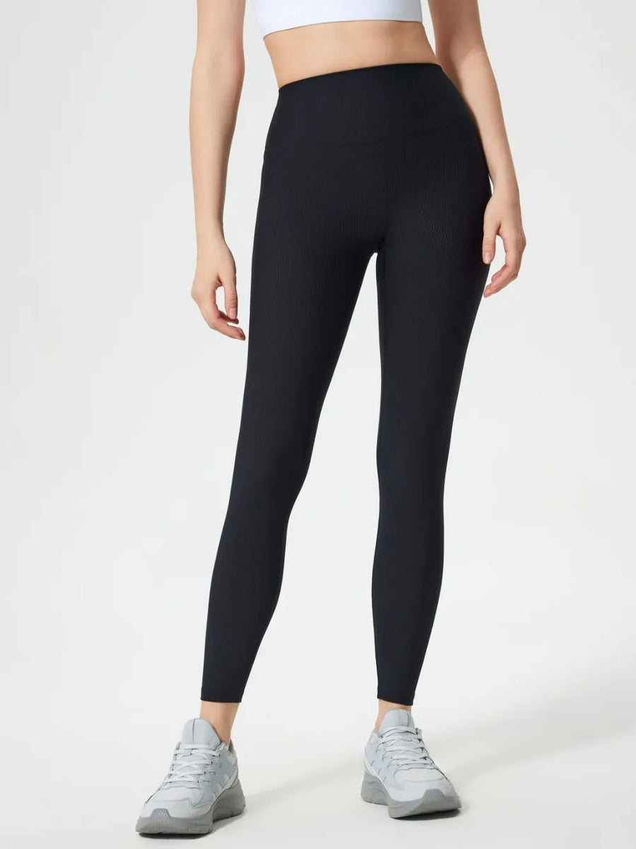 Person wearing black leggings on a white background