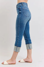 Blue jeans worn by a person on a white background