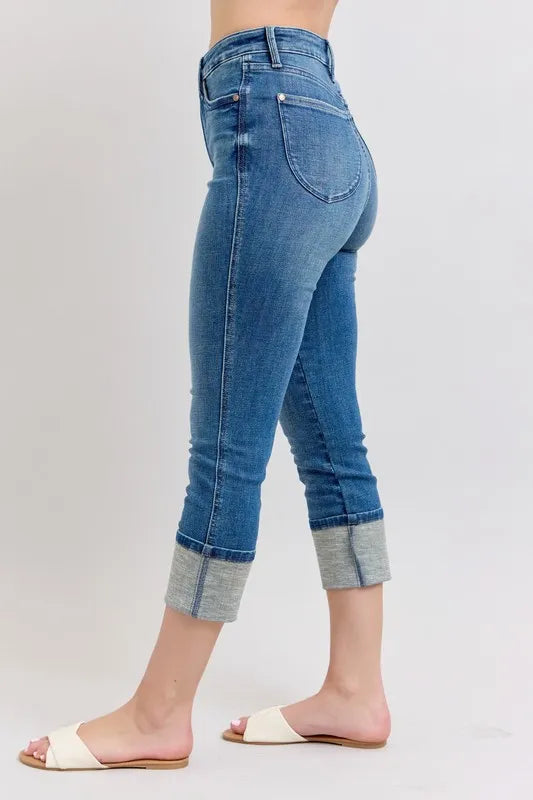 Blue jeans worn by a person on a white background