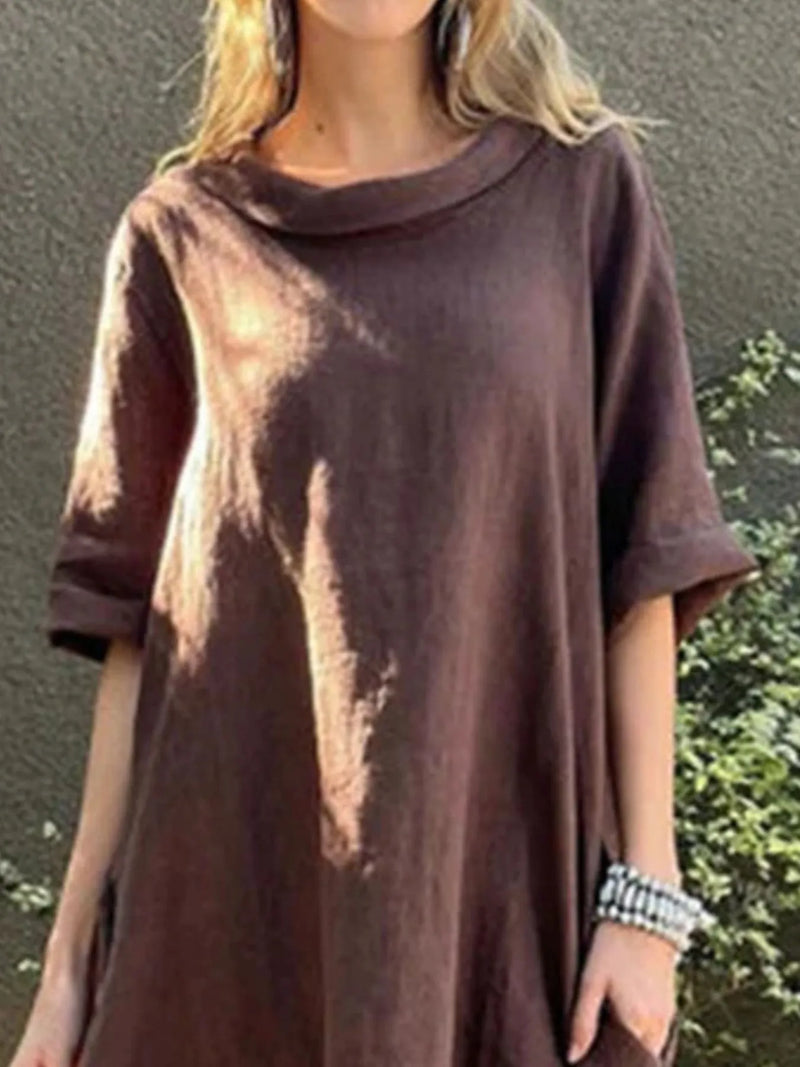 Person wearing a brown tie-dye t-shirt against a green outdoor background