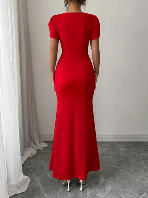 Red dress worn by a person standing against a neutral background