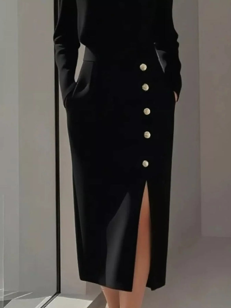 Black buttoned skirt with a high slit on a neutral background