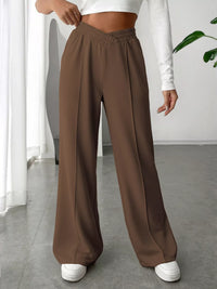 Brown wide-leg pants worn by a person indoors.