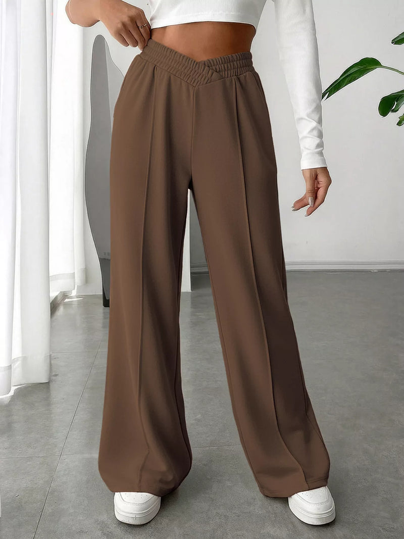 Brown wide-leg pants worn by a person indoors.