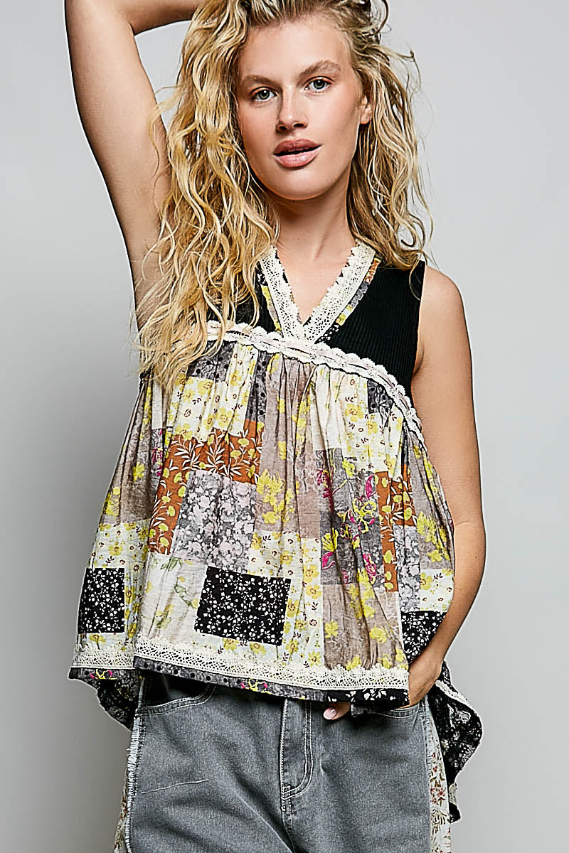 Woman wearing a colorful patterned top with a plain background