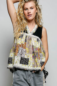 Woman wearing a colorful patterned top with a plain background
