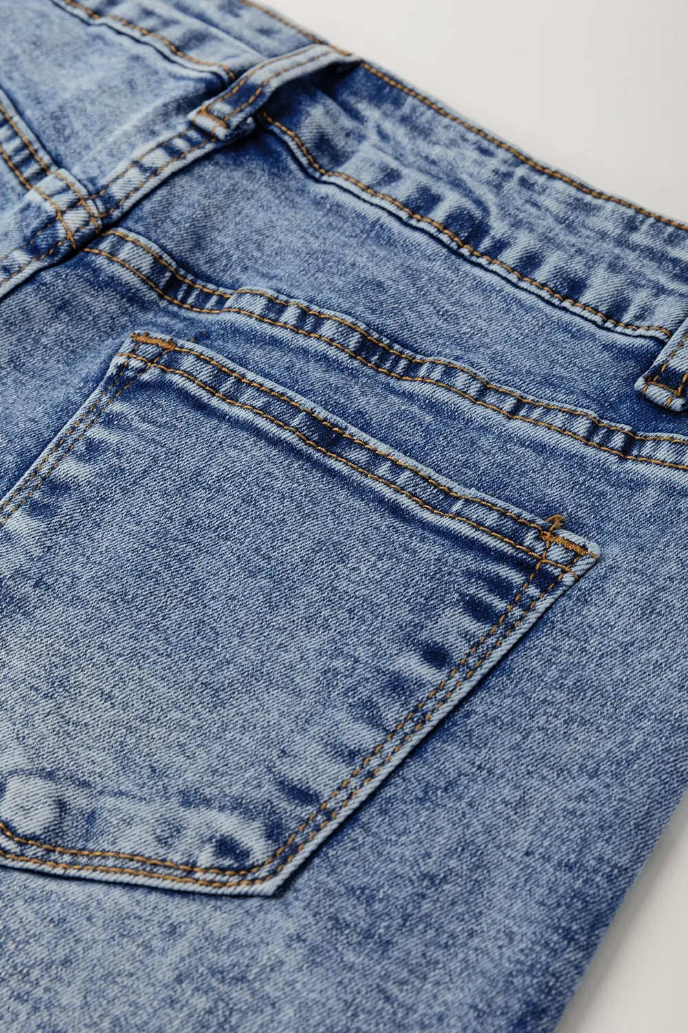 Close-up of a blue denim pocket on jeans.