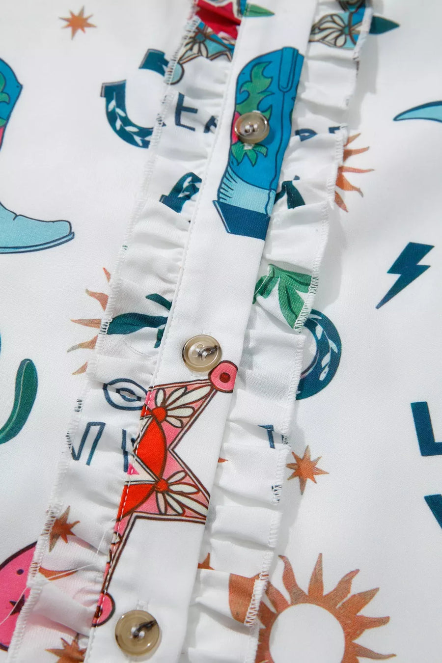 Close-up of colorful fabric with patterns and buttons on a white background