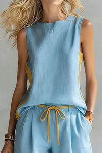 Light blue sleeveless top and pants with yellow accents on a plain background