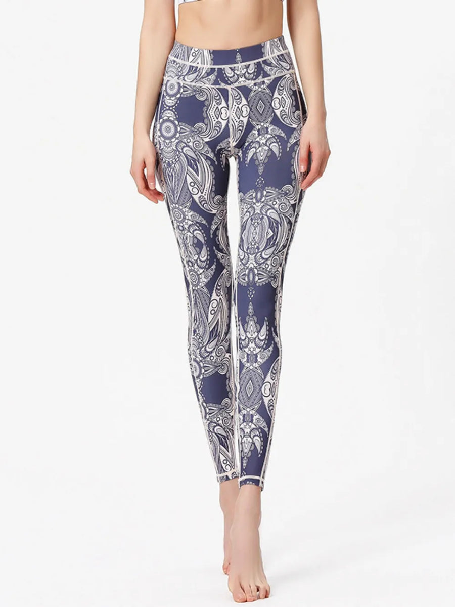 Person wearing navy blue and white patterned leggings on a white background