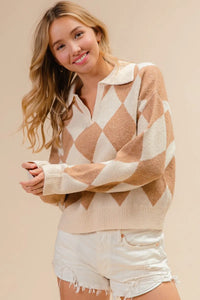 Woman wearing a beige and white patterned sweater with white shorts on a beige background