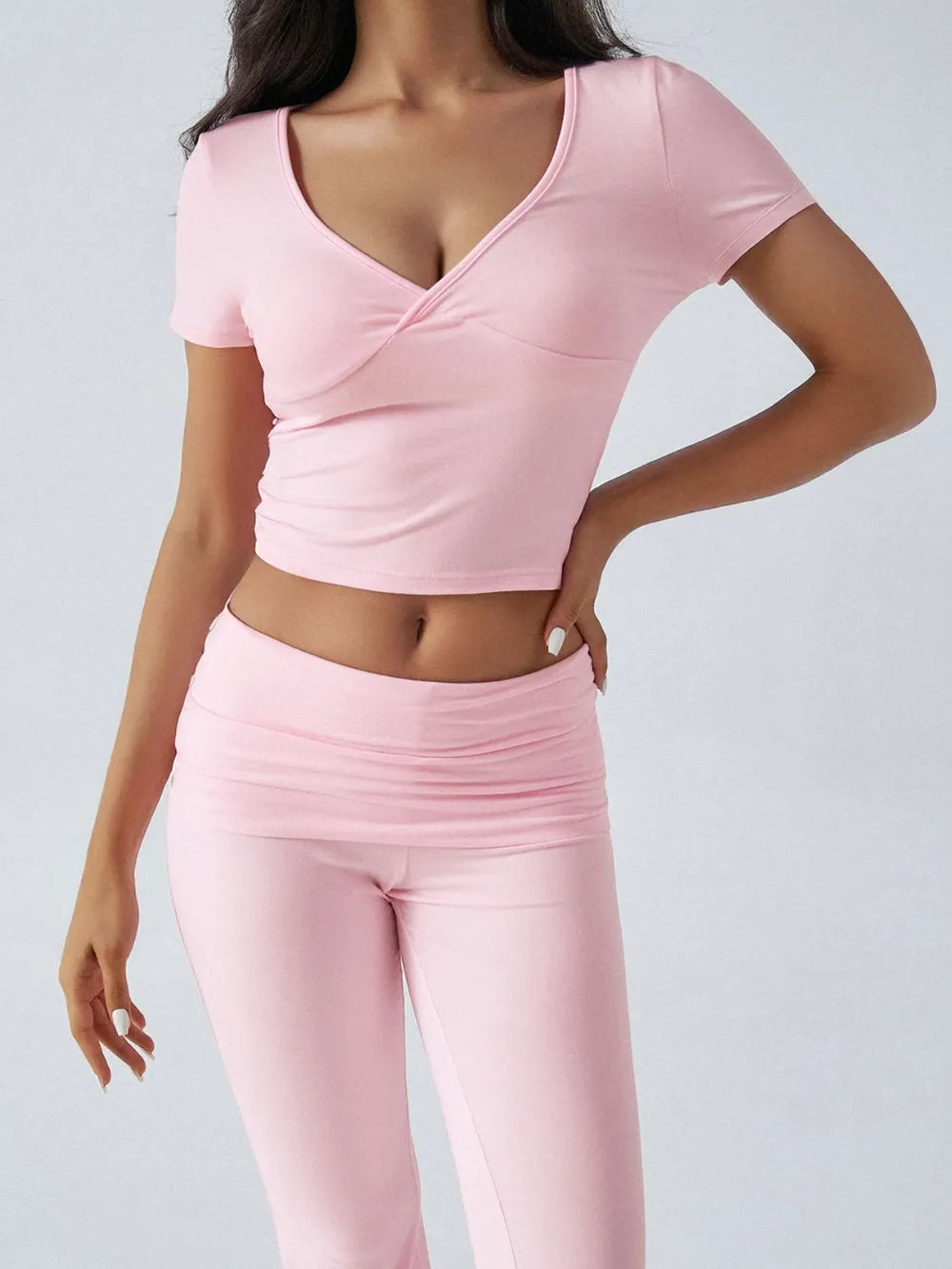 Person wearing a pink athletic outfit on a light gray background