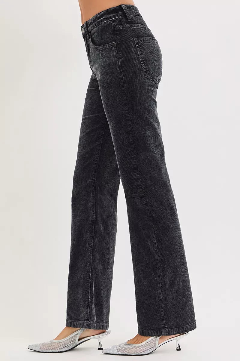 Black flared jeans worn by a person on a white background