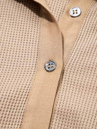 Close-up of a beige textured shirt with buttons