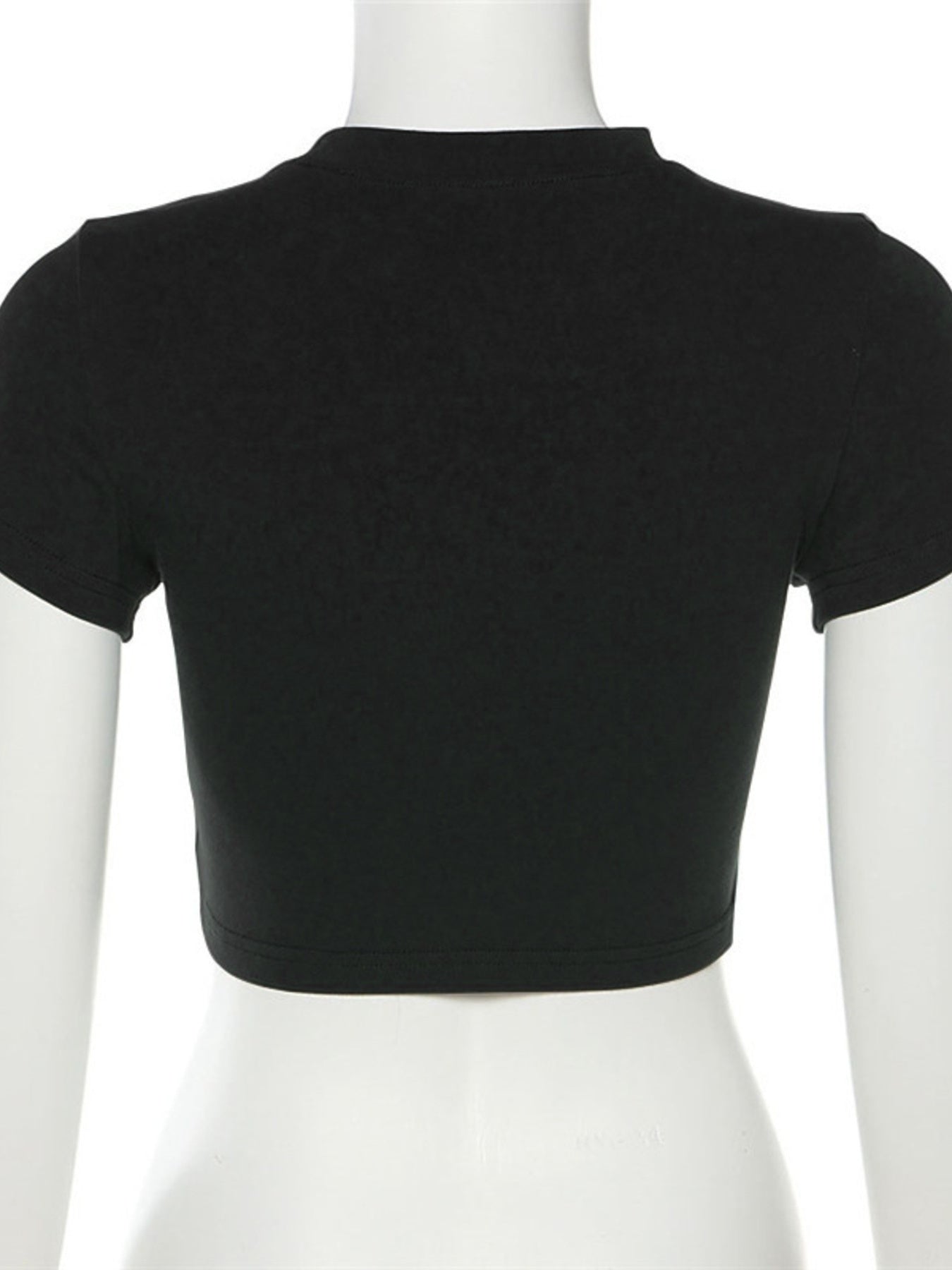 Black crop top on a mannequin against a white background