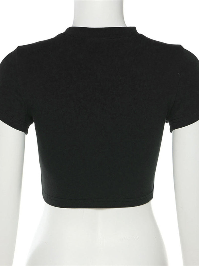 Black crop top on a mannequin against a white background