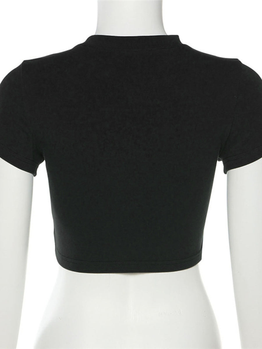 Black crop top on a mannequin against a white background