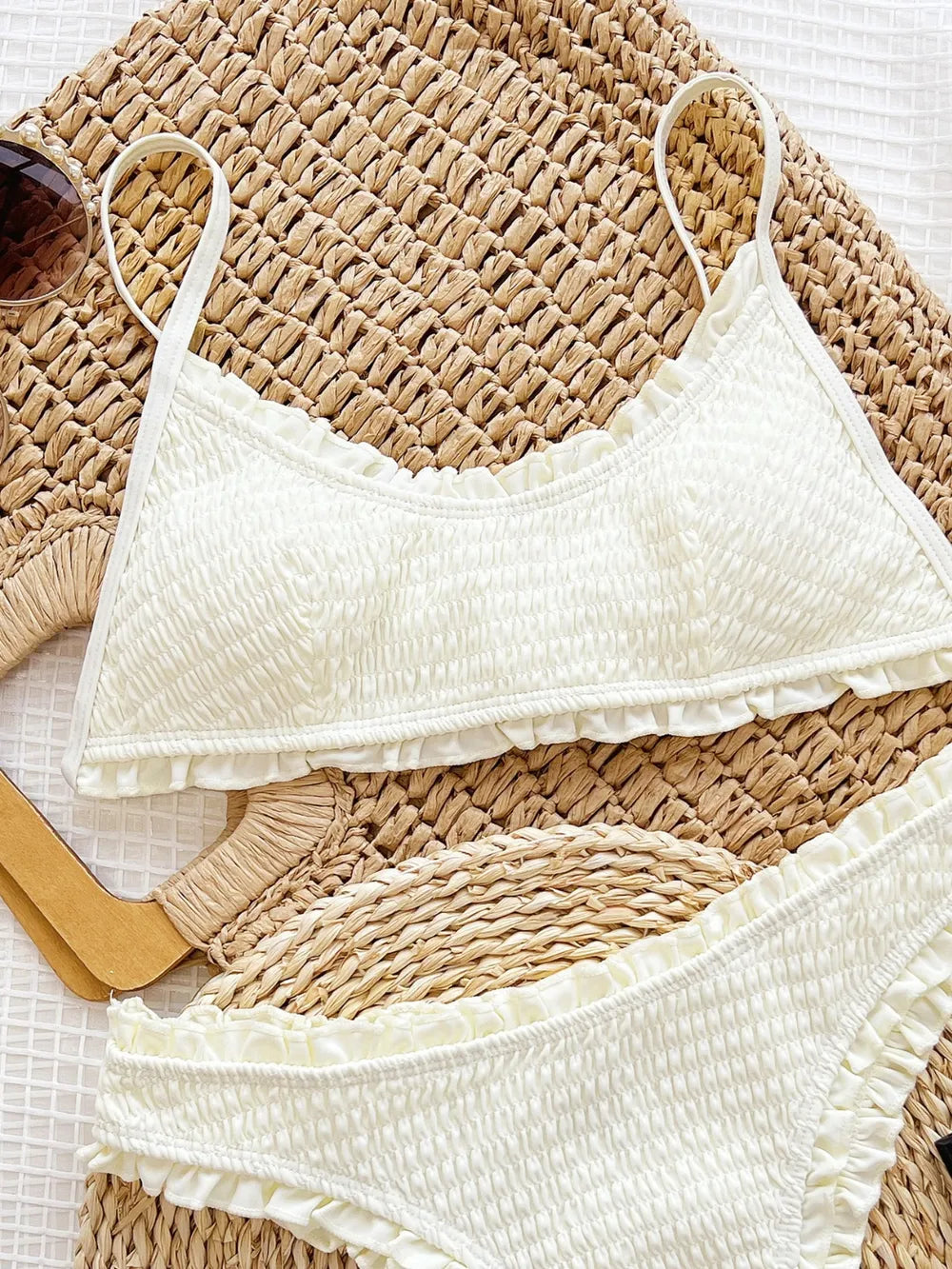 White textured bikini top and bottom on a woven mat