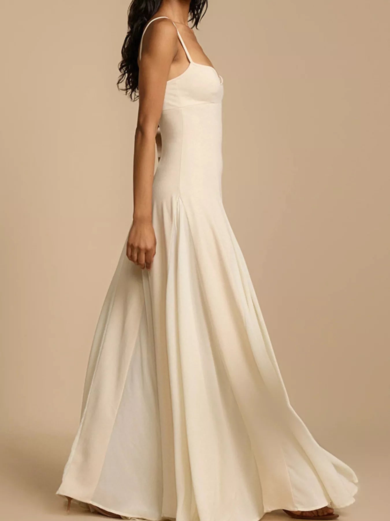 White spaghetti strap dress on a beige background