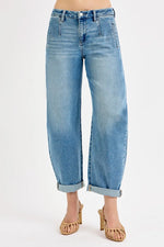 Light blue jeans worn by a person on a white background