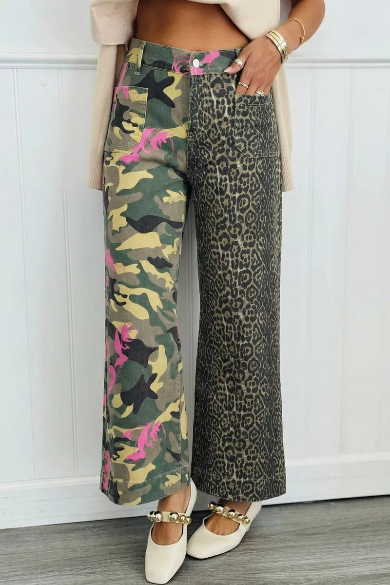 Person wearing camouflage and leopard print pants with a white background