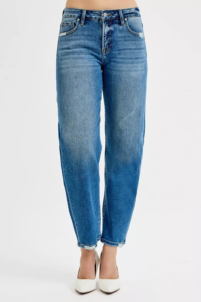Blue jeans worn by a person on a white background