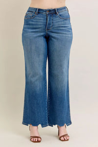 Blue jeans worn by a person on a plain background
