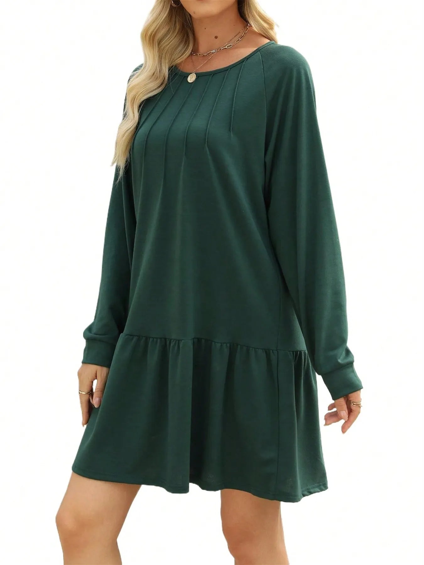 Green dress with long sleeves and ruffled hem on a white background