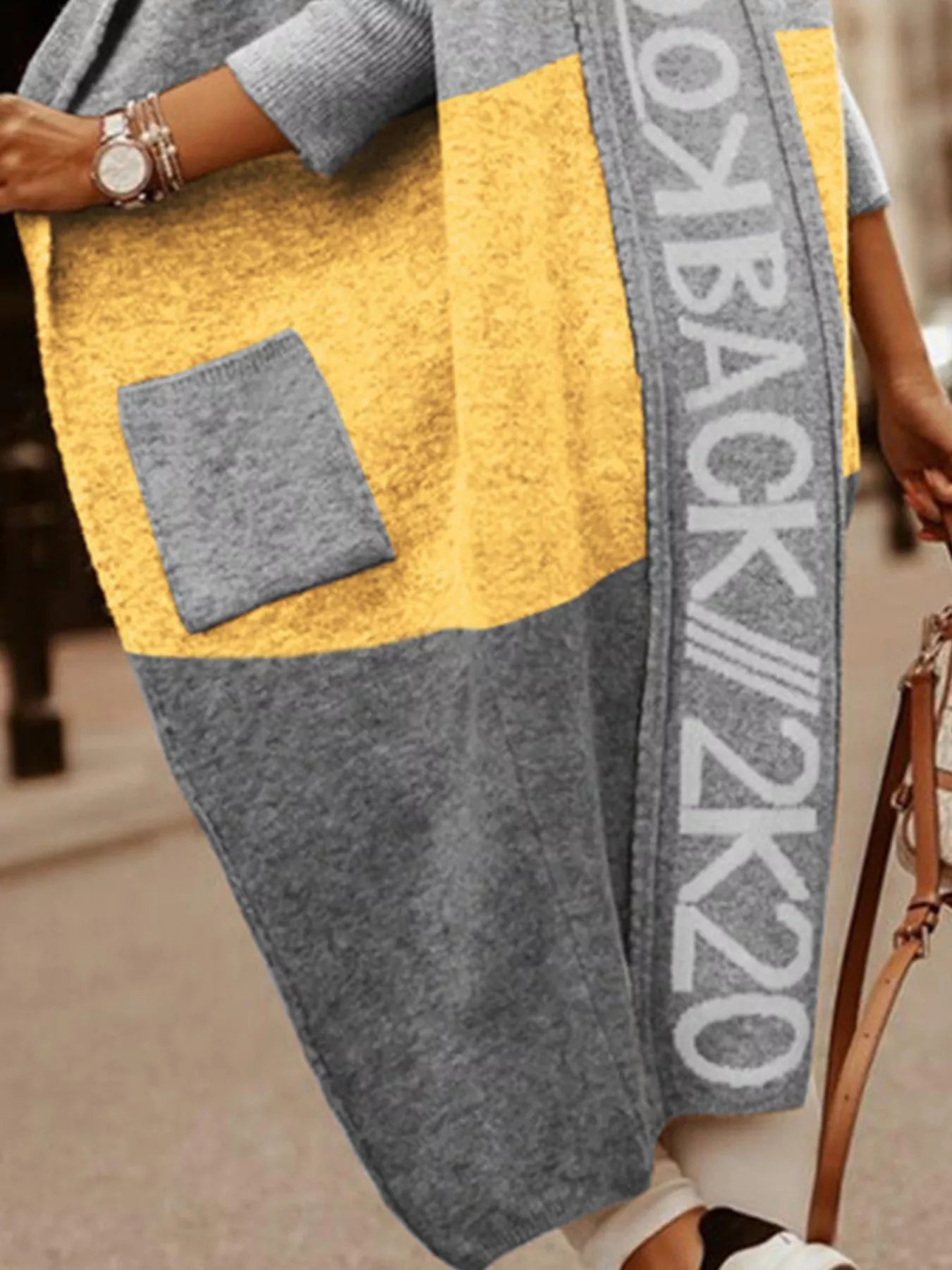 Person wearing a gray and yellow jacket with 'Back 2k20' text.
