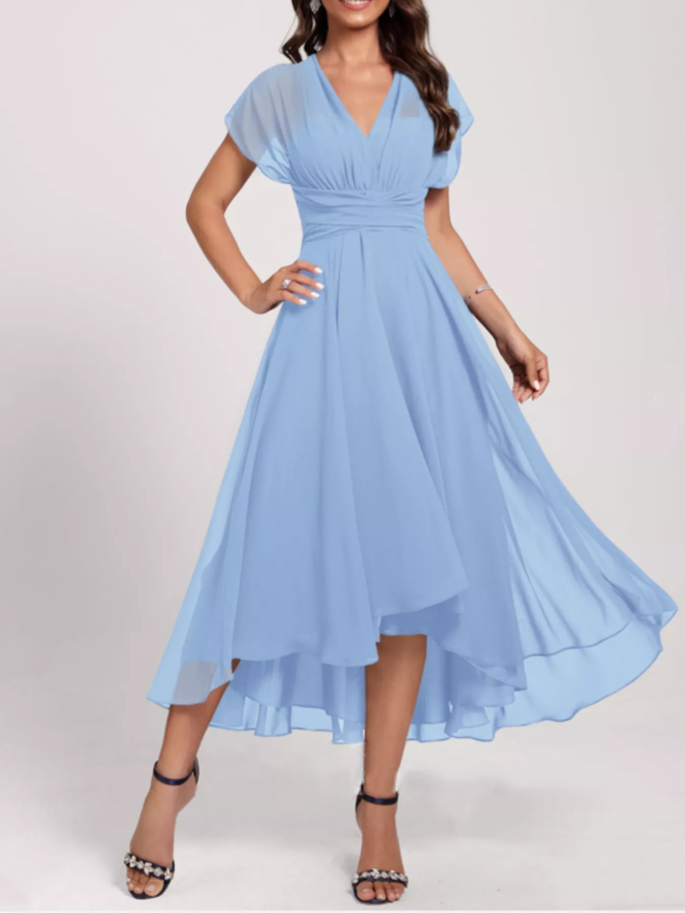 Woman wearing a light blue dress on a white background