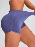 Person wearing a pair of purple athletic shorts on a plain background