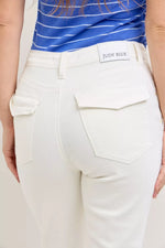White pants with a visible brand label on a neutral background